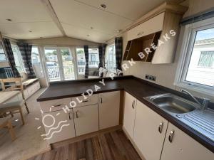 a kitchen with a sink and a counter top at Modern 3 bed; West Sands @ Seal Bay Resort in Chichester