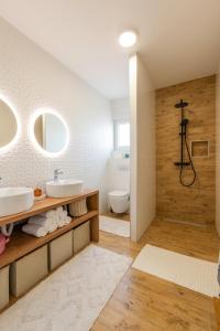 a bathroom with a sink and a toilet and a shower at Kuća za odmor Finida in Umag