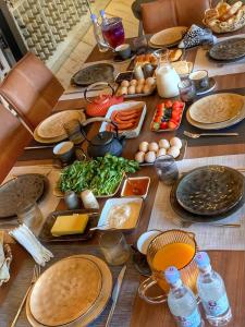a wooden table with plates of food on it at Filin Resort in Ijevan