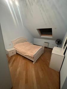a small bedroom with a bed in a attic at Opera Guest House in Yerevan