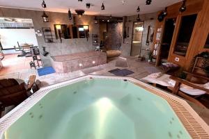 una gran bañera de hidromasaje en la sala de estar en Marcel Bruckmanns Spa - Wellness & Holiday Apt. en Erkrath