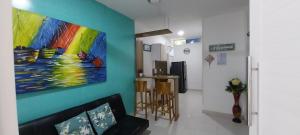 a living room with a painting on the wall at Cabañas Berakah in Coveñitas