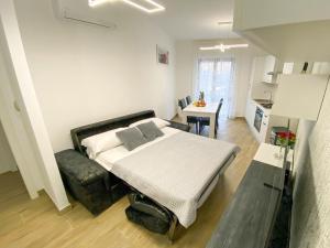 a bedroom with a bed and a table and a kitchen at Holiday House 2 in Viterbo