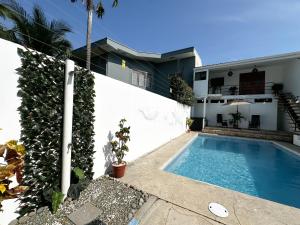 a swimming pool in front of a house at Beachfront w/ pool & rancho - Casa Coral in Puntarenas