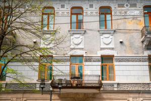 a building with a balcony on the side of it at Belona Hotel in Kutaisi
