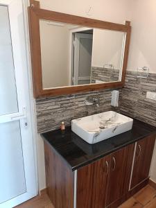 a bathroom with a sink and a mirror at You and Me at Twin Oaks kasauli in Kasauli
