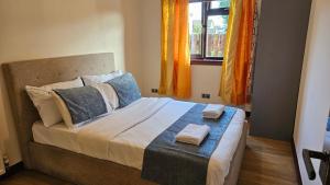 a bedroom with a bed with two towels on it at Duddingston Guest House in Edinburgh