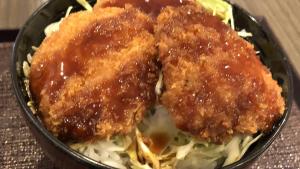 a black bowl of food with meat and cabbage at Dormy Inn Express Koriyama in Koriyama