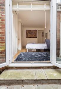 a bedroom with a bed through a window at Private room with en-suite in London