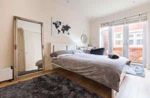 a bedroom with a bed and a large mirror at Private room with en-suite in London