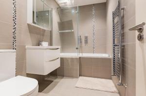 a bathroom with a shower and a toilet and a sink at Private room with en-suite in London