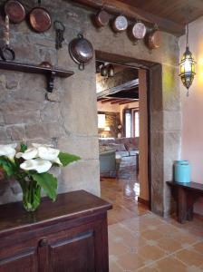 a room with a vase of flowers on a table at 14A09 Casa de la Capilla in Colunga