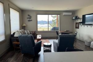 a living room with a couch and chairs and a tv at Siuslaw Tides 1 in Florence