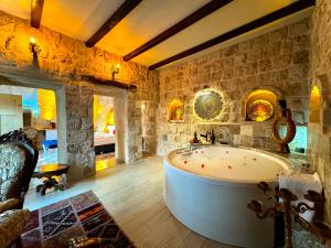 a large bathroom with a large tub in a room at THE RED HORSE HOTEL in Urgup