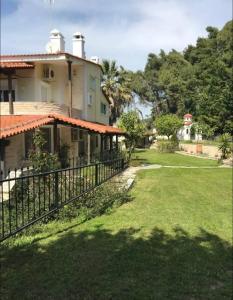 a view of a house with a fence at Posidi pool apartment in Possidi
