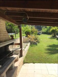 a view from under a pergola of a yard at Posidi pool apartment in Possidi