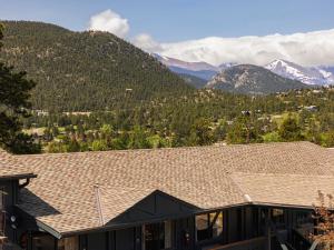 a roof of a house with mountains in the background at Trailborn Rocky Mountains Outpost in Estes Park