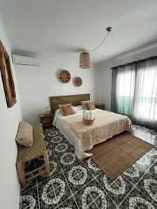 a bedroom with a bed and a table in it at Villa Cala Xuclar in Portinatx
