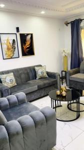a living room with a couch and a table at DAC IMMOBILIER in Yaoundé