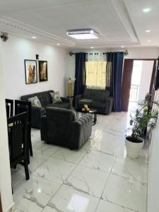 a living room with a couch and a table at DAC IMMOBILIER in Yaoundé