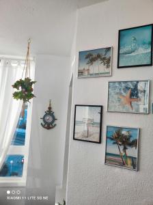 a wall with pictures of the beach on it at AlgaidaBeach-PaseoLitoral in Sitio de Calahonda +63 photos