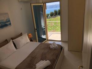 a bedroom with a bed and a sliding glass door at Ions seaview apartments in Vlorë