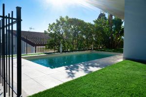 a swimming pool in a yard next to a house at Casa Mathea in Taormina