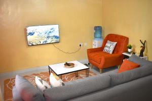 a living room with a couch and a chair at The Zen One Bedroom,Milimani, Nakuru in Nakuru