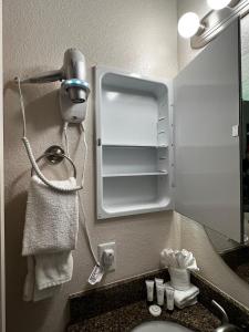 a hotel bathroom with a sink and a mirror at Canyon Plaza Premier Studio and Apartments in Tusayan