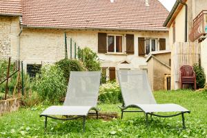 two chairs in the yard of a house at ABRICOSY Maison de campagne 6 personnes Aiglepierre in Aiglepierre