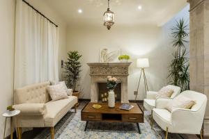 a living room with two couches and a fireplace at Casa Cielo, 4-Story Luxury Home with Rooftop Hot Tub & AC in San Miguel de Allende