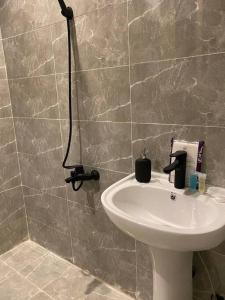 a bathroom with a sink and a shower at استديو فاخر ومميز حي الربيع in Riyadh
