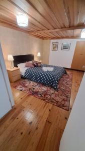a bedroom with a bed and a rug on a wooden floor at Casa em Alfama in Lisbon