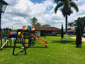 a playground with a slide in a park at Espectacular finca con piscina cerca al parque del cafe in Montenegro