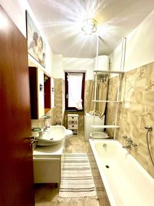 a bathroom with a tub and a sink and a bath tub at Villa Iris in Casarza Ligure +7 photos