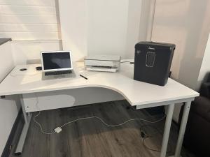 a desk with a laptop computer and a printer at Versace Suite in Blackpool