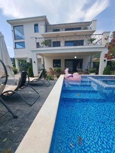 a house with a swimming pool in front of a house at Vila Romantica in Budva