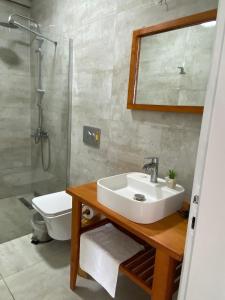a bathroom with a sink and a shower and a toilet at MAVİ ROTA BUTİK OTEL in Datca