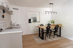 a kitchen with a dining room table and chairs at Ferienwohnung am Siglhof in Samerberg