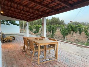 a wooden table and chairs on a patio at Casa Mimosa - Algarve in Portimão