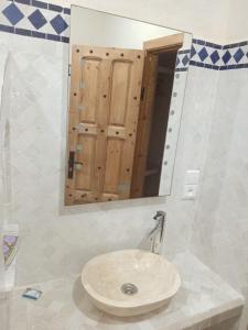 a bathroom with a sink and a mirror at Dar Rif Kebdani in Tangier