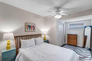 a bedroom with a bed and a ceiling fan at Amazing 1 BR apt - 1 block from Jax Beach! in Jacksonville Beach