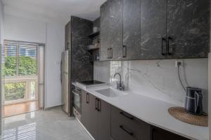 a kitchen with a sink and a counter top at Kikar Hamedina Dream 3 BR in Tel Aviv