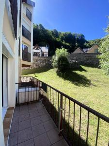 a balcony of a building with a fence and a yard at Résidence Neouvielle - Studio dans le centre de Barèges proche du jardin MAE-5411 in Barèges