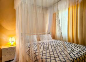 a bedroom with a bed with a canopy and a window at Luxury Suites in Seeta