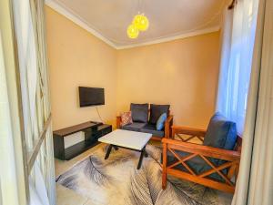 a living room with a couch and a table at Luxury Suites in Seeta