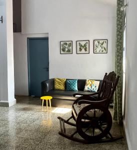 a living room with a couch and a chair at Shenvi Homestay in Panaji