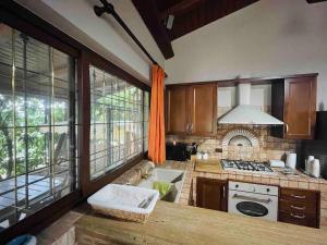a kitchen with a counter and a stove top oven at Honey's Home-Dependance campagna in Villafranca +7 photos