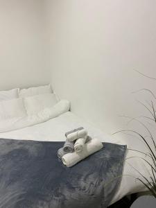 a white bed with towels on top of it at Paul’s Houses in Drama