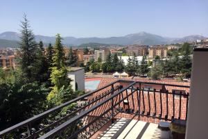 a balcony with a view of a city at Corno Piccolo [cozy home in L’Aquila city center] in LʼAquila